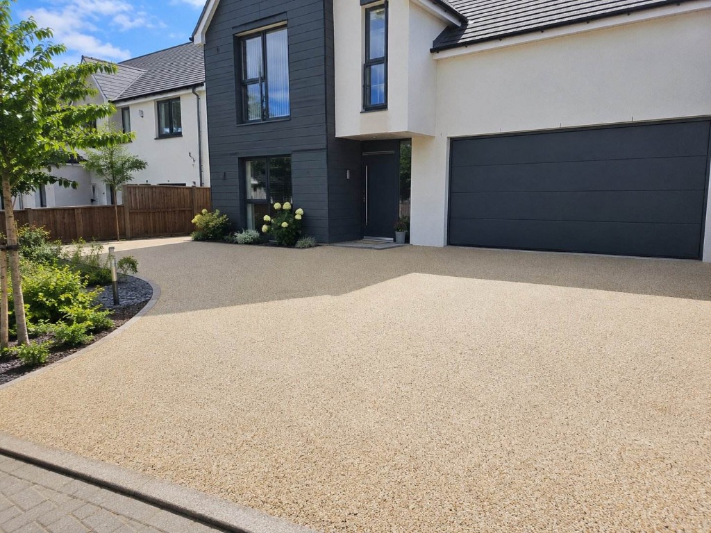 Caramel Latte resin bound driveway on modern detached home with dark cladding by Daltex Resin Experts